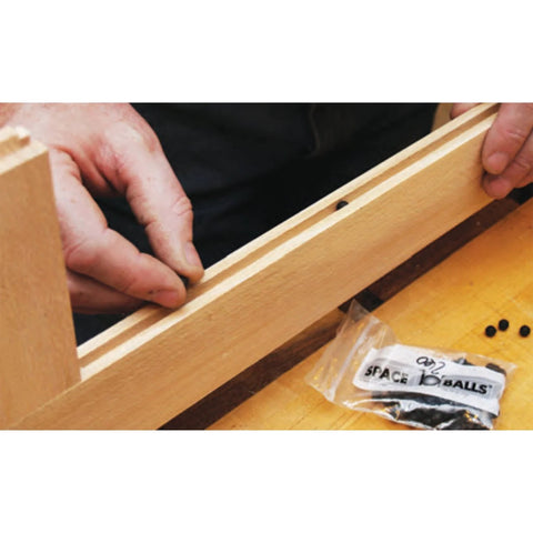 Installing wood door and panel expansion spacers 0.26 inch diameter prevent panel cracking and rattle from humidity changes