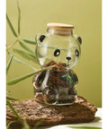 Airtight Glass Coffee Bean Jar With Fun Panda Lid Keeps Whole Beans And Grounds Locked In Heat Resistant Transparent Tea Sugar Canister Top Shelf Fresh Storage For Coffee Crew on wooden surface.