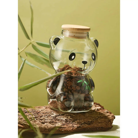 Airtight Glass Coffee Bean Jar With Fun Panda Lid Keeps Whole Beans And Grounds Locked In Heat Resistant Transparent Tea Sugar Canister Top Shelf Fresh Storage For Coffee Crew on wooden surface.