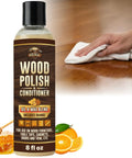 Native Bee Wax Wood Polish And Conditioner Blended With Bright Orange Oil Keep Your Furnishings Straight Up Pristine Restore Deep Color And Smooth Grain For A Clean Slick Shine 8 Oz, polished wood surface with hand and bottle.