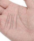 Five stainless steel pieces of the Six Pack 20G Piercing Taper Insertion Tool Set in a hand for scale.
