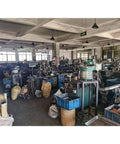 Factory floor with equipment for manufacturing Carbon Motor Brushes Replacement 2 Pack For Miter Saws And Power Tools.