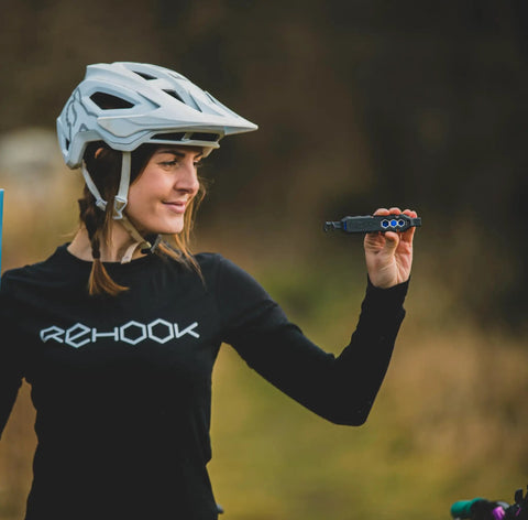 Cyclist holding multitool from Emergency Bike Repair Kit With Lightweight Cycling Toolkit Includes Multitool Air Pump Tire Levers Glueless Puncture