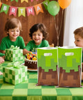 Children around cake with Pixel Game Themed Party Favor Bags Pack Of 30 With Handles Colorful Video Game Style Goodie Bags on table