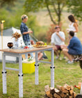 Level Up Your Setup With Four Piece White Metal Table Leg Extenders For Folding Desks Adjustable Height Risers on picnic table.