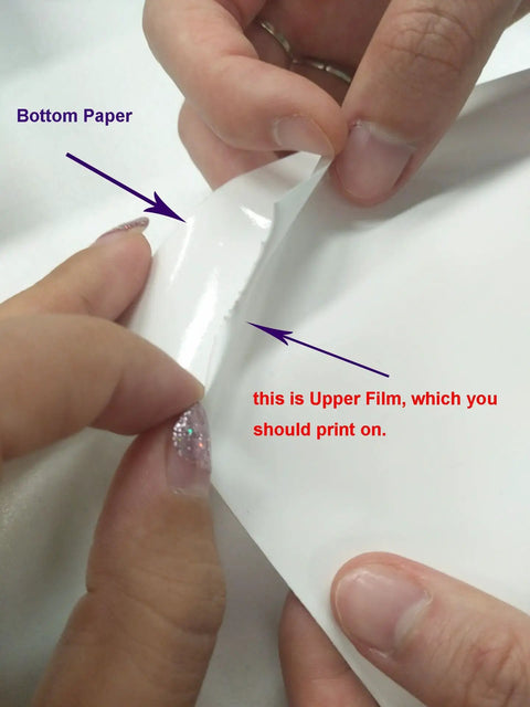 Hands peeling Printable White HTV Vinyl Roll, 24 Inch Wide By 5 Yard Length, showing printable upper film and bottom paper