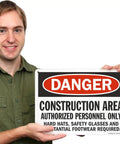 Person holding a Heavy Duty Aluminum Danger Sign For Construction Area Locking Out Unauthorized Crews With Straight Up Rust Resistant Outdoor Wall Mounts For Any Day One Job Site Project.