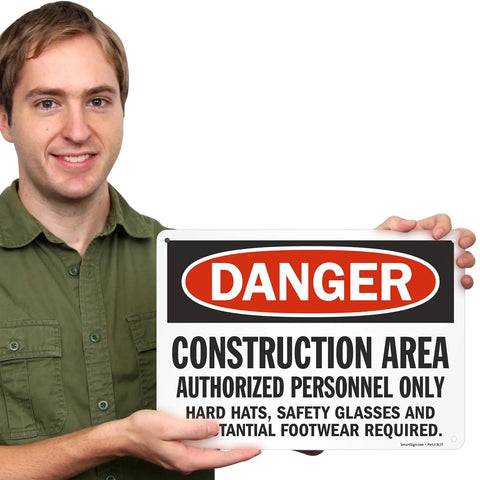 Person holding a Heavy Duty Aluminum Danger Sign For Construction Area Locking Out Unauthorized Crews With Straight Up Rust Resistant Outdoor Wall Mounts For Any Day One Job Site Project.