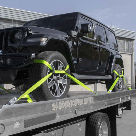 Black vehicle secured with Eight Point Vehicle Tie Down Kit With Snap Hook Ends And Chain Tail On Ratchet Ends Set Of Four Reflective High Viz Neon Webbing.