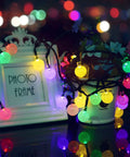 Solar Outdoor String Lights With 60 LED Crystal Globe Bulbs 8 Modes 26ft Waterproof Fairy Lights illuminating in darkness