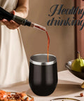 12oz Double Wall Vacuum Insulated Stemless Wine Tumbler With Straw And Lid Stainless Steel Cup Keeps Drinks Ice Cold Or Piping Hot All Day Perfect For Backyard Hangs And Weekend Sippin Vibes in black pouring red wine.