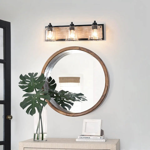 Three-Light Bathroom Vanity Light 23 Inch Large Fixture With Bubble Glass Shades over a round mirror and plant decor