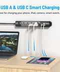 Ultra Thin Surge Protector Power Strip With USB A And Type C mounted on wall above wooden desk with devices connected