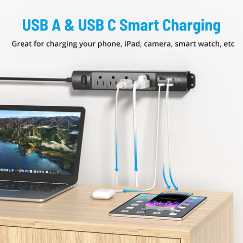 Ultra Thin Surge Protector Power Strip With USB A And Type C mounted on wall above wooden desk with devices connected