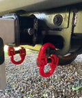 Heavy Duty Alloy Steel Coupling Links 4 Pack 1/4 Inch Grade 80 Hammer Lock Chain Connectors attached to a trailer hitch.