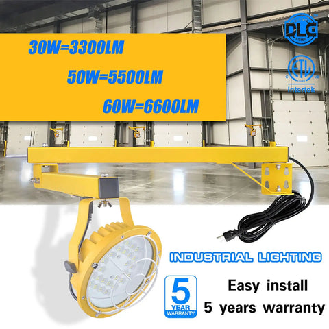 Tough As Nails 30W LED Loading Dock Light With 43 Inch Swivel Arm 3300 Lumen mounted on yellow arm in an industrial warehouse.