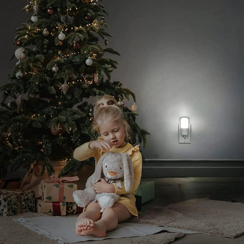 Child with toy near Dimmable Plug In Night Light With Dusk To Dawn Sensor, 5000K Daylight, Stepless 0 To 80 Lumens Brightness