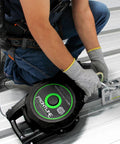 2-Way Standing Seam Roof Anchor Clamp For Non-Penetrating Roof Safety, Rugged Reusable And Compact Steel Anchor With 5,000 Lbs Strength Rating, OSHA And ANSI Compliant, Galvanized Finish, Bolts And Washers Included being installed on standing seam roof by worker.