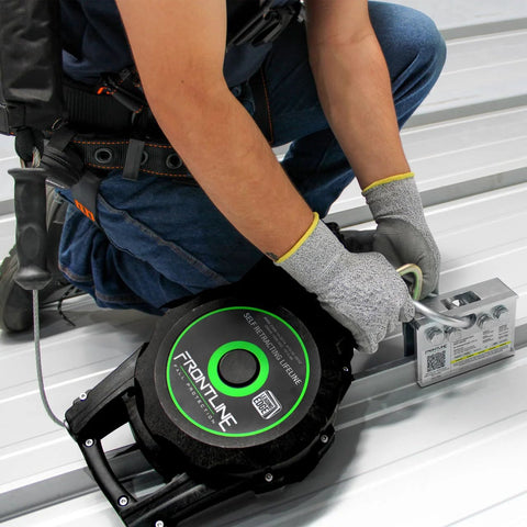 2-Way Standing Seam Roof Anchor Clamp For Non-Penetrating Roof Safety, Rugged Reusable And Compact Steel Anchor With 5,000 Lbs Strength Rating, OSHA And ANSI Compliant, Galvanized Finish, Bolts And Washers Included being installed on standing seam roof by worker.