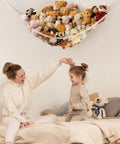 Corner Hanging Stuffed Animal Storage Hammock Net For Plush Toys Large Capacity Toy Organizer above mother and child