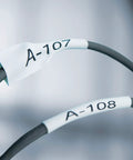 Close-up of cable labels printed with RhinoPRO 5200 Heavy Duty Label Maker, showing durable labels for job site use.