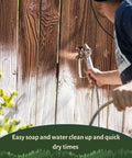Man spraying Top Shelf Penetrating Exterior Wood Stain In Acorn Brown 5 Gallon on wooden fence with a sprayer.