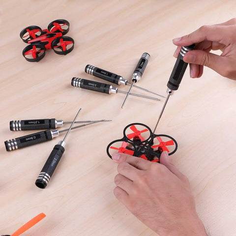 Pro RC Hex Driver Set 7Pc Hex Allen Screwdriver Kit used to repair small drone on a wooden table