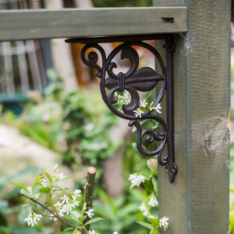 Heavy Duty Iron Corner Braces Tough As Nails Floating Shelf Supports Wall Mounted Triangle Plant Stand Steel L Brackets Set Of Two No Sweat Install Rugged Hardware Gear decorative black iron corner bracket on wooden post with flowers.