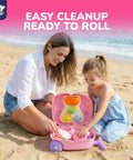 Mother and child playing with Unicorn Themed Rolling Sand Toy Suitcase For Kids Beach Fun with Water Play Table on the sand.
