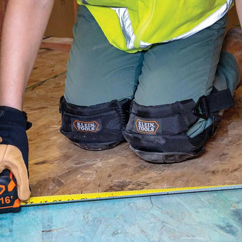 Person wearing All Day Comfort Hinged Gel Knee Pads With Slip Resistant Rubber Caps, Quick Release Clips And Adjustable Straps on wooden floor.