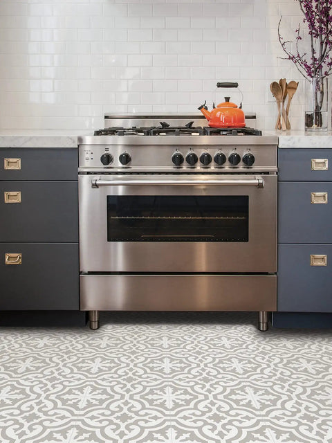 Emilia Peel And Stick Floor Tiles In Neutral Grey And White Farmhouse Style in kitchen setting under a stainless steel oven.