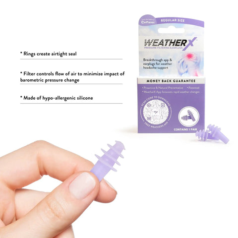 Hand holding purple headache prevention earplug with pressure filtering tech for barometric weather shifts, packaging in background