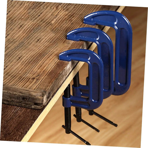 4-Inch Metal G Clamp Desk Mount Quick Woodworking Clamp Beefy Heavy-Duty Tabletop Grip holding wood securely on table edge