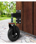 Heavy Duty Spring Loaded Caster Wheels 600 Pound Gate Rollers For Metal Tubing, black rubber wheel mounted on wooden gate.