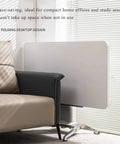 No Sweat Adjustable Height Rolling Drafting Desk With Flip Top And Book Stop Lightweight White Mobile Workstation Craft Table For Home Office Easy Roll Setup Stepless Tilt Surface Built Solid, showing folding design next to a sofa.