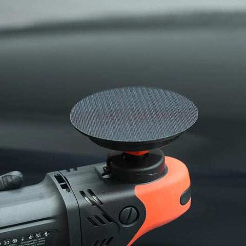Close-up of a black polisher with Two Pack Rotary Backing Plate With Hook And Loop Surface For Polisher Sander 5 Inch 5 By 8 By 11 Thread Orange PU Soft Backing Pad For Easy Sanding Polishing Buffing And Finishing, showcasing a smooth hook-and-loop surface.