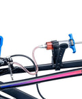 BKM12 Hydraulic Brake Bleed Kit For Mineral Oil With Dual Syringes attached to bike frame for bleeding purpose