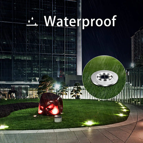 12-Pack Solar Ground Lights 8-LED In-Ground Pathway Lights Outdoor Waterproof illuminating lawn at night with waterproof text.