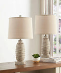 Rustic Dual USB Table Lamps Set Of 2 For Bedroom And Living Room 3 Way Dimmable Nightstand Lamps With Linen Fabric Shades Built In USB Ports Modern Classic Lighting Includes LED Bulbs displaying beige ceramic bases with linen shades on a table stand.