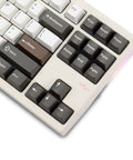 Badass Cnc Aluminum Mechanical Keyboard Featuring Smooth Triple Mode Wireless Connectivity Quick Release Design And Dope Hot Swap Pbt Keycaps close-up of keys with brown and black keycaps, showcasing function buttons.