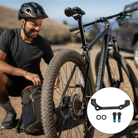 Post Mount Disc Brake Adapter Kit For Front 180mm Rear 160mm Conversion Caliper Mount Spacers For MTB And Road Bikes Easy Plug And Play Brake Upgrade Today with cyclist and mountain bike in background