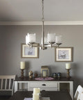 Modern Farmhouse 19 Inch 5 Light Chandelier In Brushed Nickel Finish With Frosted White Linen Glass Shades in dining room setting