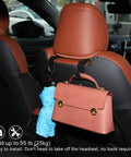 Mazda CX50 Interior Upgrade Kit headrest hook holding a pink handbag and umbrella inside a 2023-2025 CX50 Hybrid.