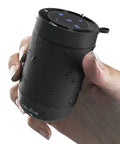 Hand holding a waterproof portable Bluetooth speaker with wireless stereo pairing and built-in mic, 360 degree HD sound.