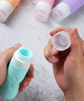 Opening a blue silicone Leak Proof TSA Approved Travel Bottles Set 3oz Refillable Containers For Shampoo Conditioner Lotion Body Wash Multicolor.