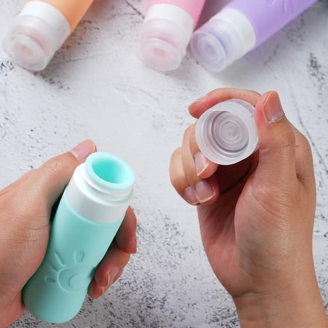 Opening a blue silicone Leak Proof TSA Approved Travel Bottles Set 3oz Refillable Containers For Shampoo Conditioner Lotion Body Wash Multicolor.