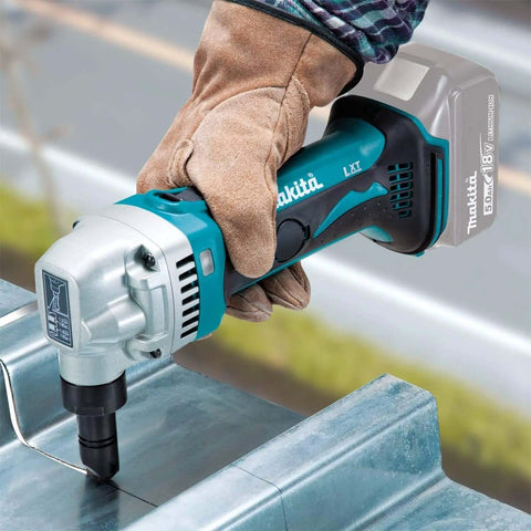 Worker using 18V LXT Cordless 16 Gauge Metal Nibbler, Tool Only, 1,900 SPM, Rotating Die Holder 360 Degrees on metal sheet