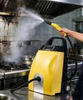 Heavy Duty 3000 Watt Industrial Steam Cleaner With Hot Water Power For Kitchen Grease And Appliance Care Fast 20 Second Heat Up At 4-5 Bar Pressure Professional Grade Cleaning Tool Using Pure Water Only No Chemicals Needed To Scrub Away Dirt And Grime in use with steam nozzle cleaning a greasy kitchen hood.
