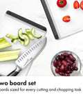 Two Piece Cutting Board Set For Kitchen Prep with tomatoes, cucumbers, and olives on non-porous boards with knife