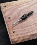 Three Piece Countersink And Drill Bit Set With Hex Wrench, Includes Sizes Six, Eight And Ten, shown installed in wood for woodworking projects.